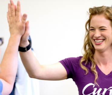 Curves coach high-fiving another woman
